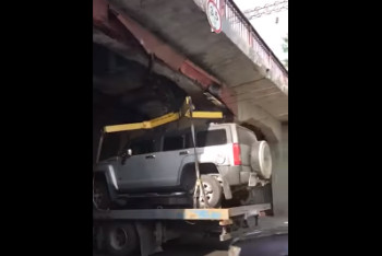 Фотография к новости: Алматинцы сняли курьезное видео застрявшего под мостом полицейского эвакуатора 